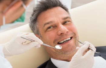 Patient Smiling at the Dentist Providing Dental Checkup Atlanta GA