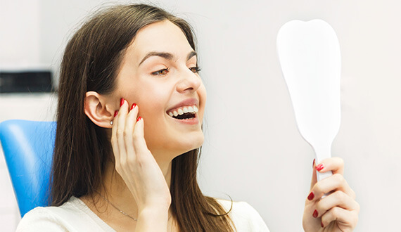 smiling patient after emergency dentistry procedure